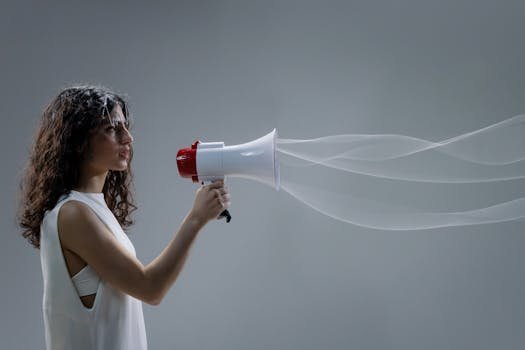 pexels-photo-7859937-7859937 Woman using a megaphone emitting sound waves on a gray background.
